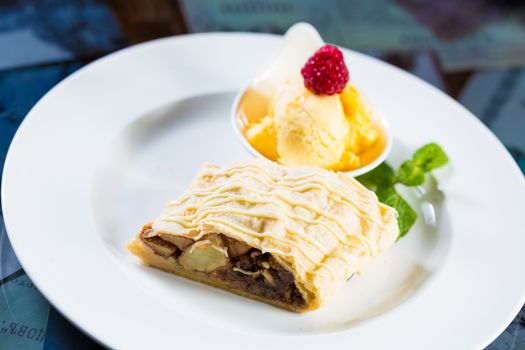 Apple strudel with icing sugar,almonds and vanilla ice cream for Christmas