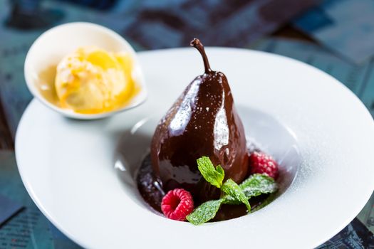 pears in the chocolate. Creative cuisine. Dessert. selective Focus
