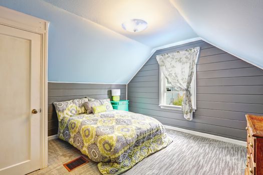 Light grey bedroom interior with vaulted ceiling and plank paneled walls