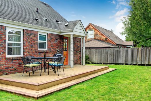 Brick house with walkout wooden patio area