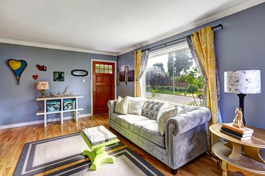 Lavender tone living room interior with comfortable sofa and green coffee table