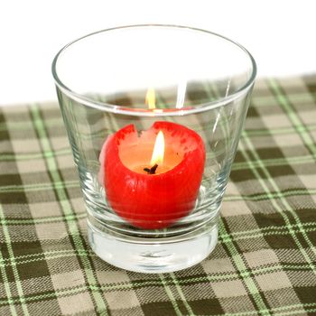 Red candles in glass tableware.