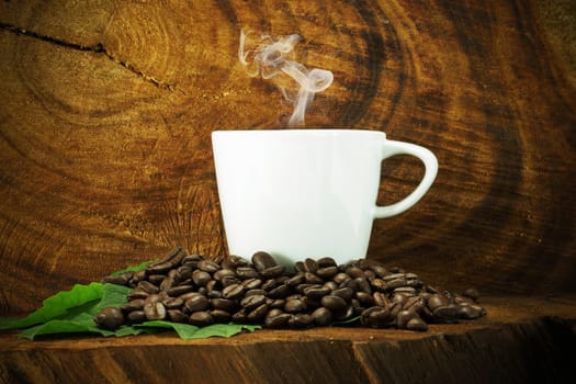 Coffee and beans on the wooden background.