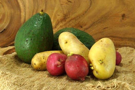 Vegetables and fruits on wooden background.