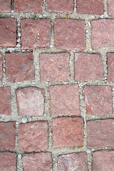 old reddish stone pavement mounted on gravel