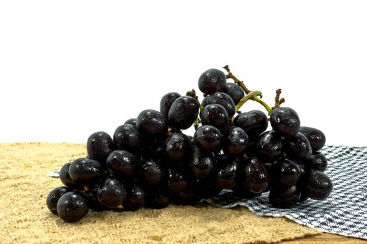 Ripe black grapes on wood