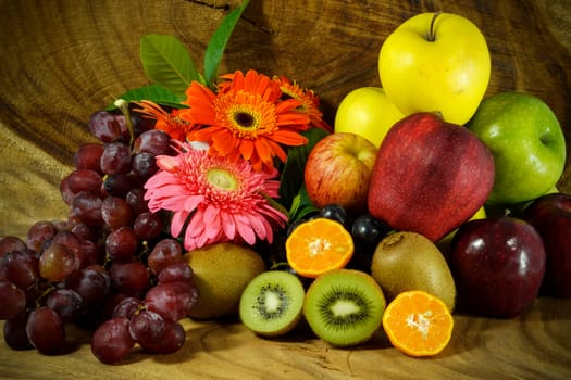 Assortment of exotic fruits on wood background.