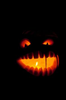 Halloween pumpkin with scary face on black backgound