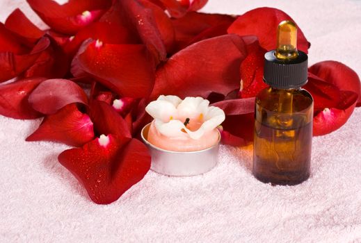 Spa Treatment with aromatic roses, petals, oil, and candle.