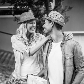 Hip young couple going for a bike ride in black and white