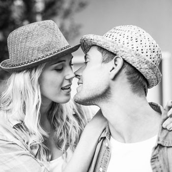 Hip young couple about to kiss in black and white
