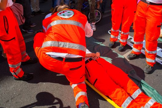 MILAN, ITALY - MAY, 18: Emergency personnel render aid to a girl during an emergency simulation on May 18, 2014