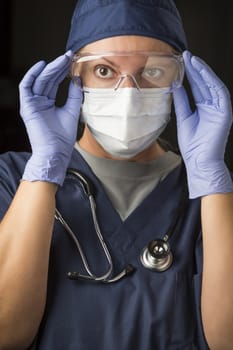 Concerned Female Doctor or Nurse Putting on Protective Facial Wear.