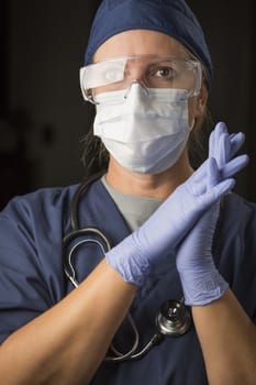 Concerned Female Doctor or Nurse Wearing Protective Facial Wear and Surgical Gloves.