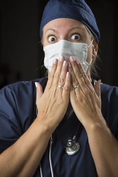 Shocked Looking Female Doctor or Nurse with Hands in Front of Mouth.