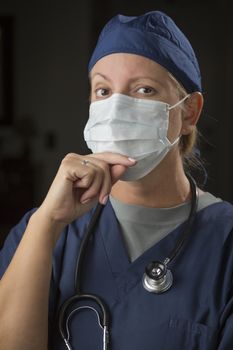 Concerned Female Doctor or Nurse Wearing Protective Face Mask.
