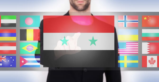 Hand pushing on a touch screen interface, choosing language or country, Syria