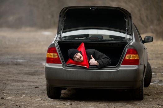 Travelers waiting for assistance in a broken car