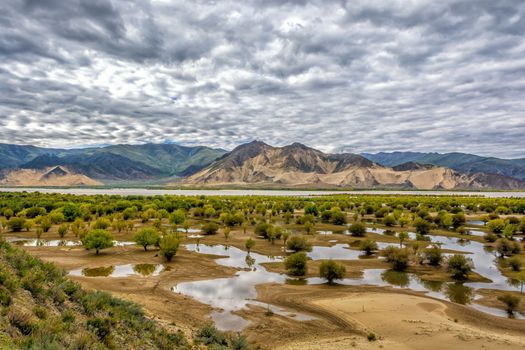 The Brahmaputra river with cloudy sky in Tibet.