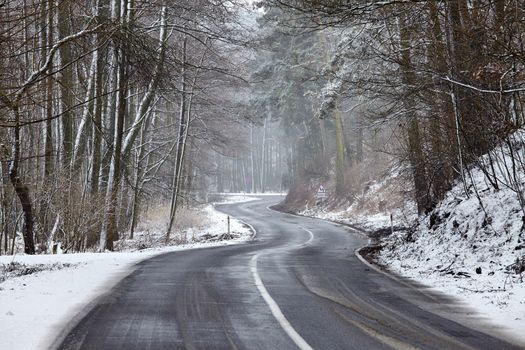 Snowy road in winter landscape