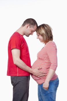 happy expecting couple holding each other - isolated on white