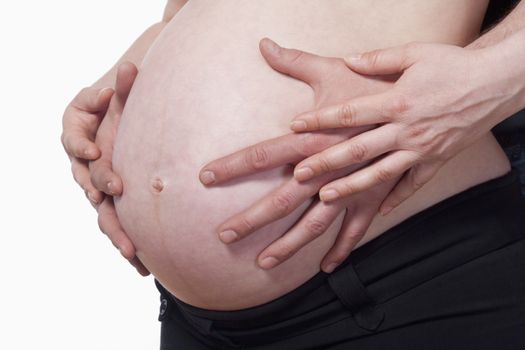 closeup of a pregnant woman touching her belly - isolated on white