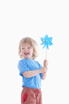 studio shot of a boy playing with pinwheel - isolated on white