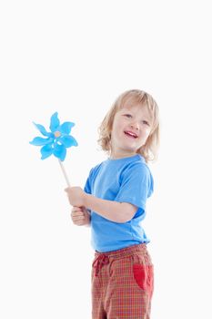 studio shot of a boy playing with pinwheel - isolated on white