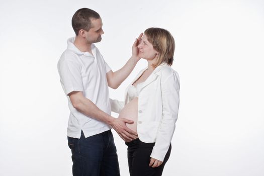 happy expecting couple holding each other - isolated on white