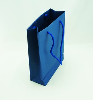 Blue shopping bag, there are two sides to hold a rope handle, on a white background.                               