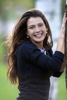 portrait of a beautiful brunette standing in birch forest