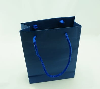 Blue shopping bag, there are two sides to hold a rope handle, on a white background.                               