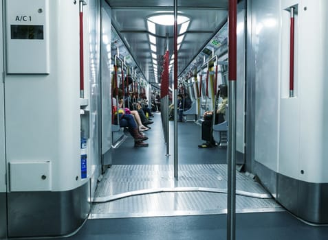 HONG KONG - APRIL 14, 2014: People in city subway train. More than 90 percent of locals use the efficient public transportation system.