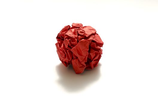 red crumpled paper ball on a white background