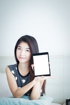 Young Asian woman show or display tablet with white blank screen