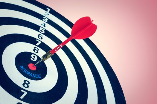 Business life insurance concept and darts board