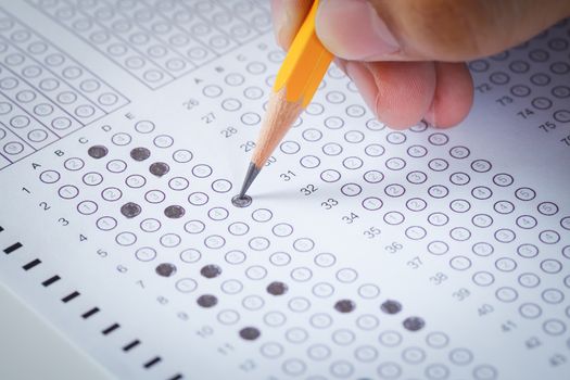 hand fill in Exam carbon paper computer sheet and pencil