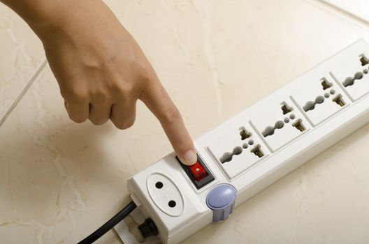 asia woman hand turn on switch multiple  socket plug electric
