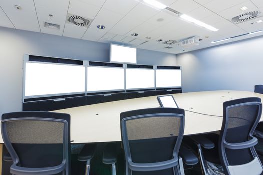 teleconferencing, video conference and telepresence business meeting room with blank screen display monitor