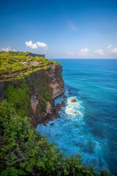 Surf waves and turqoise water along the coast of Bali