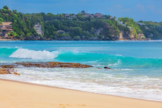 Surf waves and turqoise water along the coast of Bali