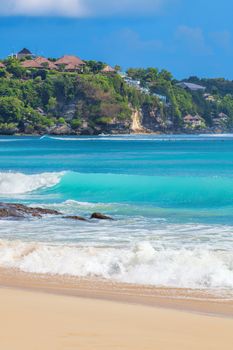 Surf waves and turqoise water along the coast of Bali