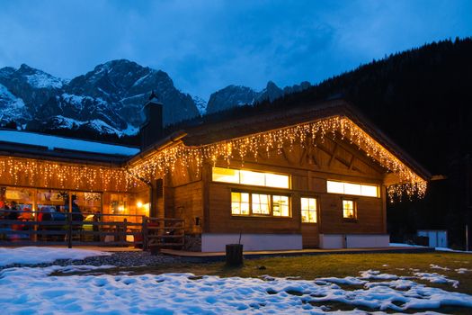 Alpine cottage in winter mountains in Austria 