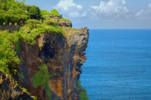 Surf waves and turqoise water along the coast of Bali