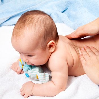 Masseuse massaging 5 months infant