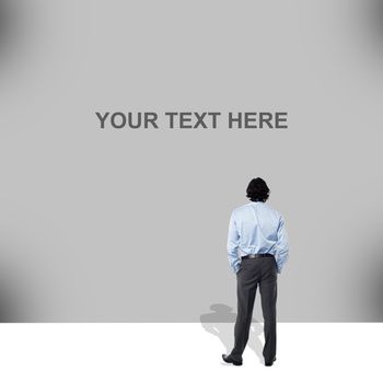 Businessman standing and looking big blank banner