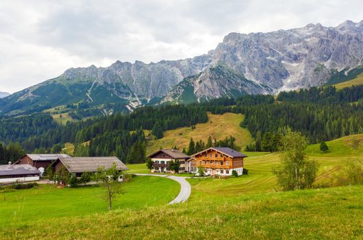 A beautiful view of the austrian alps with typical mountain houses, Austria