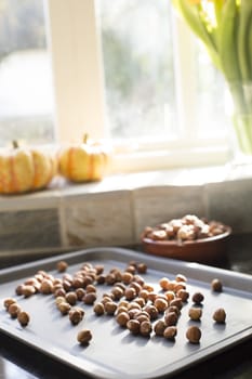 Hazelnuts on baking sheet sitting on counter ready for roasting