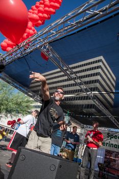 TUCSON, AZ/USA - OCTOBER 12:  Unidentified man releases red baloon for AIDSwalk on October 12, 2014 in Tucson, Arizona, USA.
