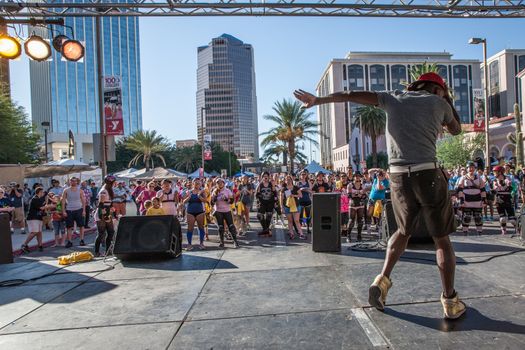 TUCSON, AZ/USA - OCTOBER 12:  Unidentified entertainer warms up crowd of walkers at AIDSwalk on October 12, 2014 in Tucson, Arizona, USA.